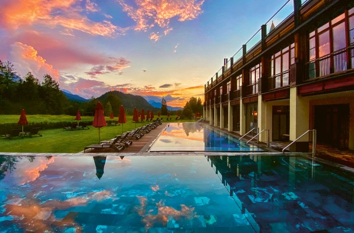 A serene hotel pool surrounded by mountains