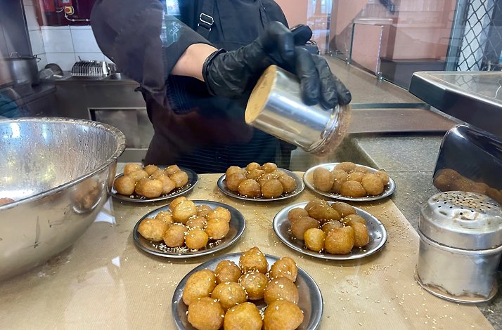 A chef preparing authentic greek cuisine.