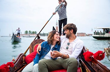 A couple together at Venetian canals.