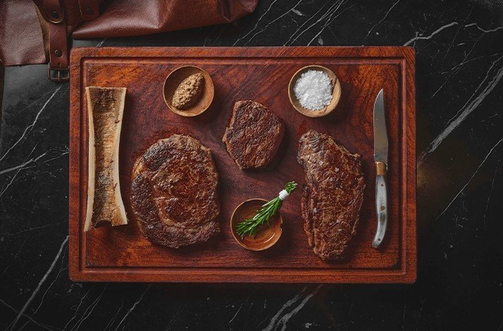 Serving steaks and condiments on a tray at Park Hyatt Bangkok.