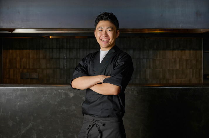Chef Ryu Shunsuke in dark uniform standing with arms crossed.