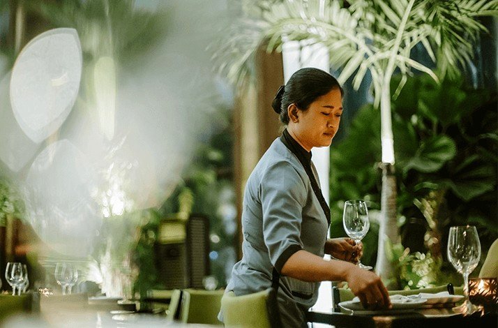 A waitress serves tables at Merah Putih.