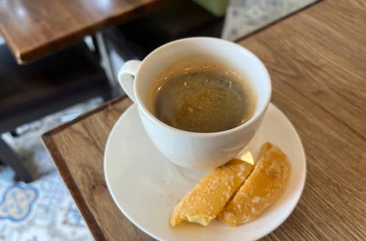 A cup of coffee from beans picked in Amadeo, Cavite with cookies.