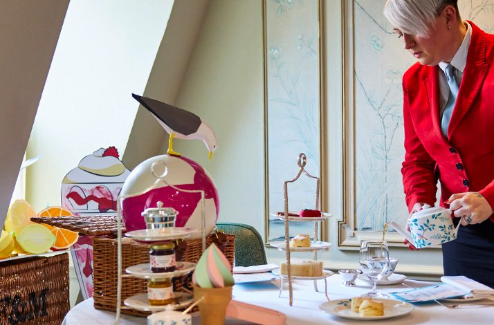 A server pouring tea at the Fortnum & Mason Diamond Jubilee Tea Salon.