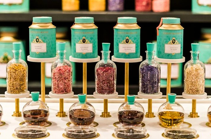 Tea ingredients and blending jars displayed at the tea counter.