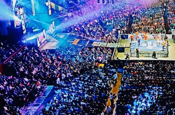Dive into the action-packed world of lucha libre in Mexico City: In Mexico City, Mexico A lively wrestling event with a cheering crowd and dazzling stage effects