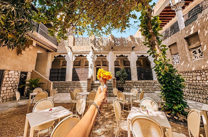 Person is holding an ice cream at the Arabian Tea House courtyard in Al Fahidi Historical Neighbourhood, Dubai.