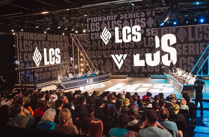A crowd in front of people on stage at an LCS event.