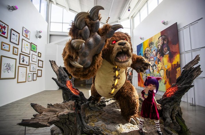 Giant Tibbers and Annie statue in a bright Riot Games office art gallery.