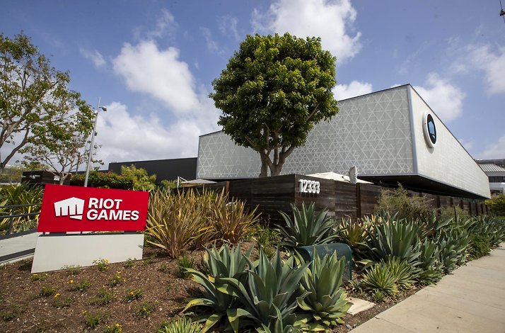Exterior view of Riot Games headquarters with logo and modern architecture.