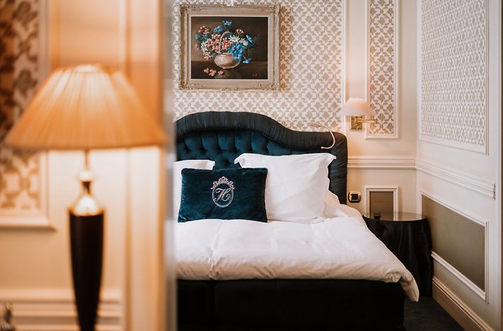 View of a bed in one of the rooms at Hotel Heritage.