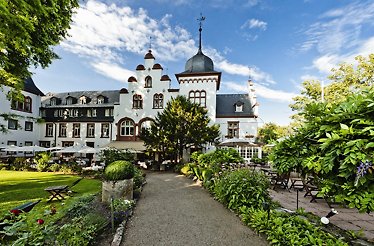 The building of Hotel Kronenschlösschen with beautiful garden in front of it