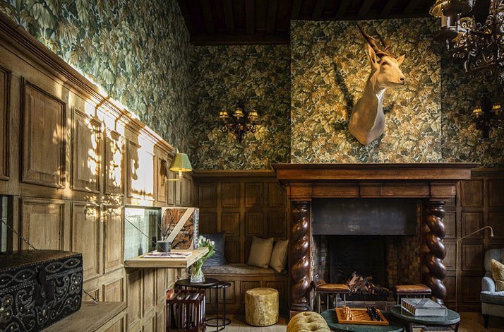 Promotional Poster for QL Hotel de Orangerie displaying a room with a fireplace