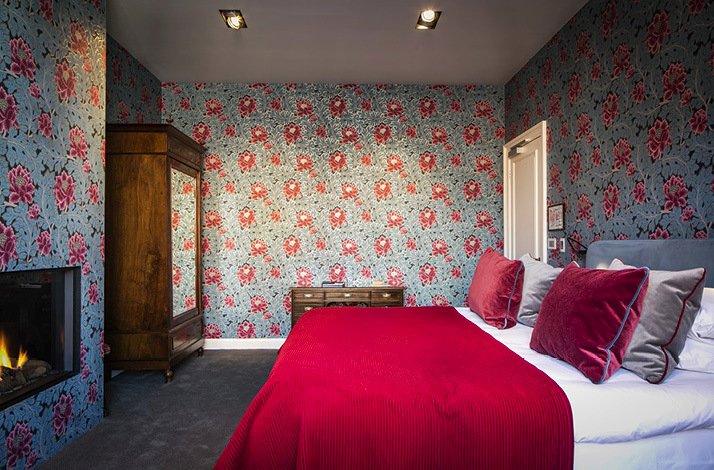 Promotional Poster for QL Hotel de Orangerie with red interior room 