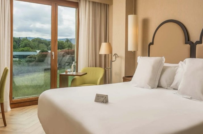 One of the rooms at Hotel ARTIEM Asturias with a large white bed.