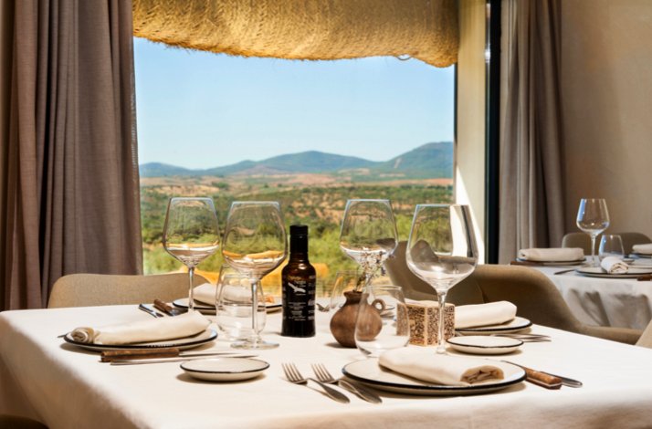 Elegantly set dining table with panoramic countryside views