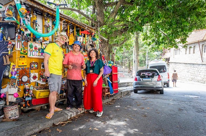 Eclectic roadside stand filled with trinkets and handmade crafts under a shady tree