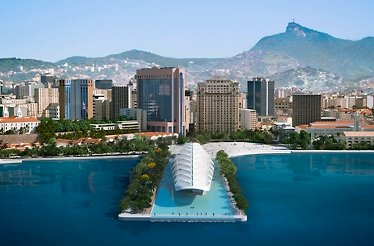 Rio de Janeiro skyline featuring the Museu do Amanhã surrounded by water, with mountains in the background.