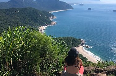 A person overlooking Recreio dos Bandeirantes from a cliff