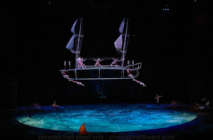 Cirque du Soleil artists performing on a ship frame suspended over a pool