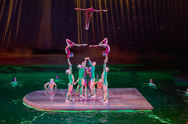 Cirque du Soleil artists performing tricks on a floating platform