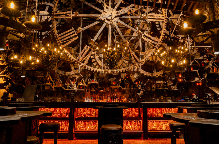Various steampunk decorations inside The Iron Fairies, a giant Iron clock is in the middle of the photo.