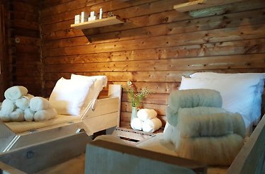 Rustic wooden spa with cozy beds and fluffy wool, perfect for relaxation