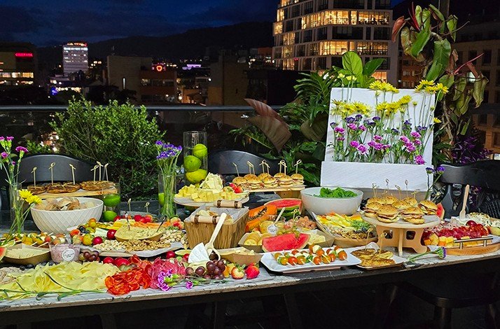 Lavish rooftop buffet with colorful food spread and decorated floral arrangements