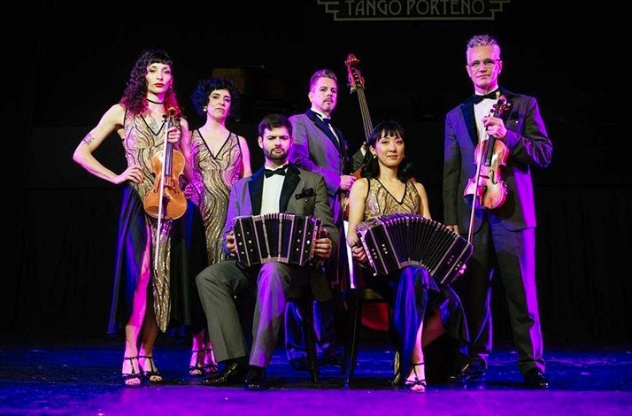 Elegant musicians with classic instruments set for a tango performance