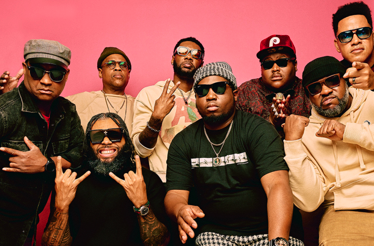 Promotional banner for ensemble The Soul Rebels with saxophonist Karl Denson.