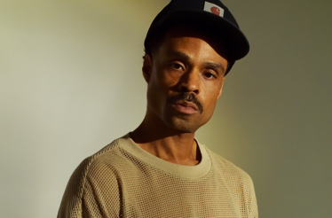 Promotional banner with Bilal, a Grammy Award-winning American singer-songwriter.