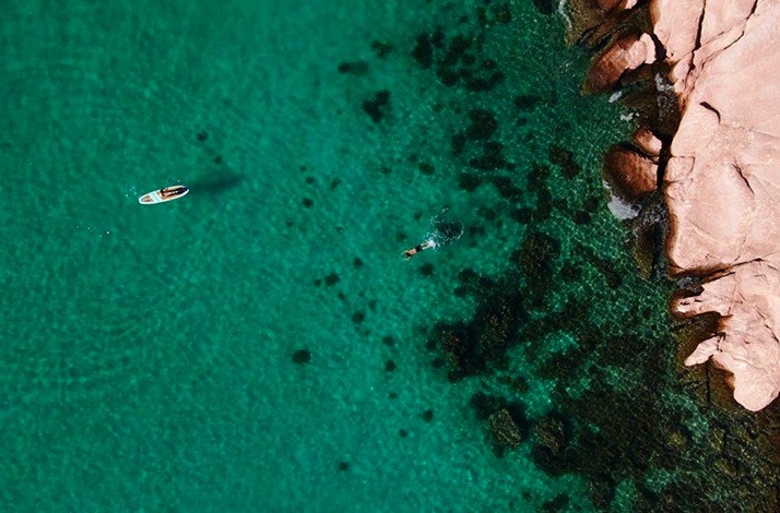 Bird's eye-view from Mexico Balandra Beach with people swimming on the surface of the tranquil water.