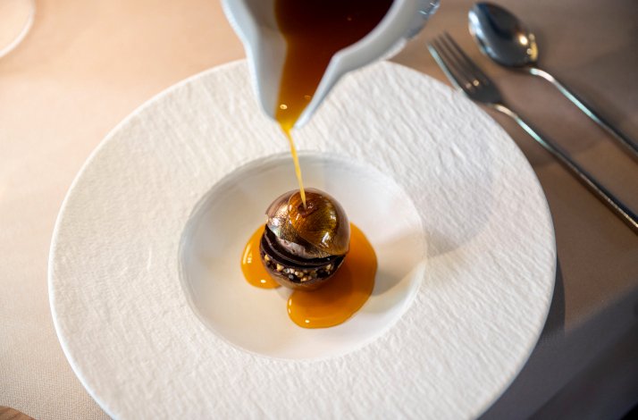 One of the iconic dishes with sauce being poured on from above by Chef Daniel Canzian.