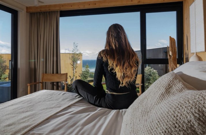 Cozy bedroom with an ocean view and natural lighting