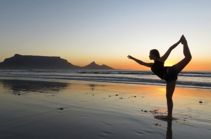 Yoga by the beach at sunrise, embracing nature and serenity