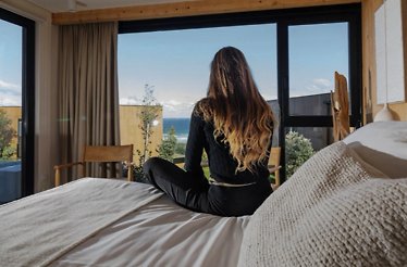 Cozy bedroom with an ocean view and natural lighting