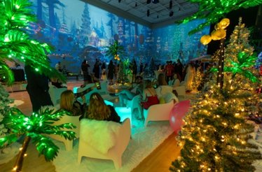 People gathered in a Christmas-decorated lobby during the exclusive evening