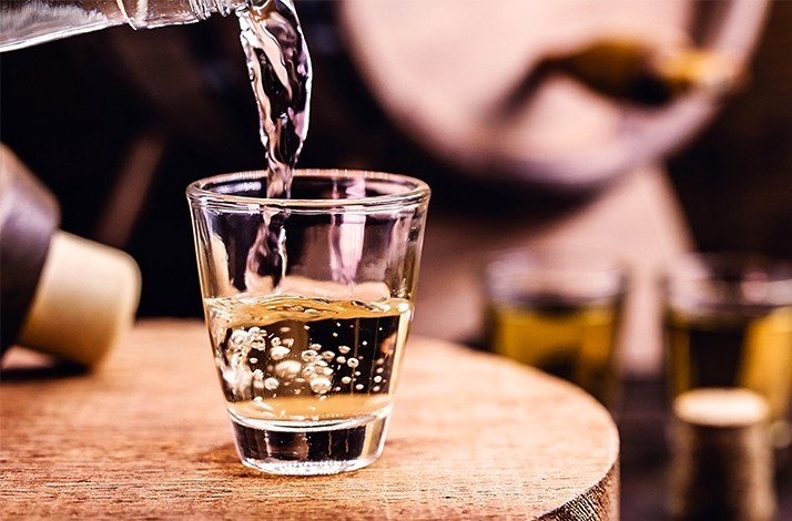 Pindorama cachaça flows into a shot glass.