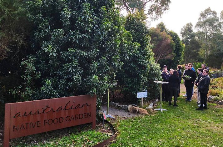 A group of people are gathered at the Australian Native Food Garden, as part of the tour for Peppermint Ridge Farm.
