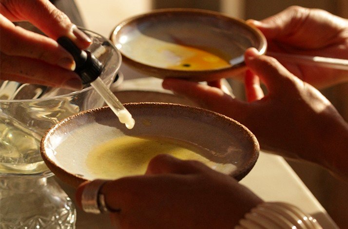 A white natural pigment being transferred using a dropper on a class of artist Fabiana Burr.