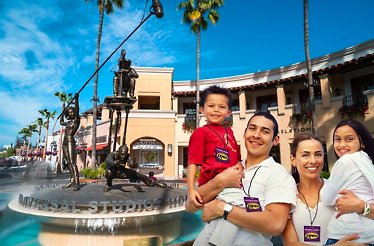 Family posing at the entrance to Universal Studios Hollywood