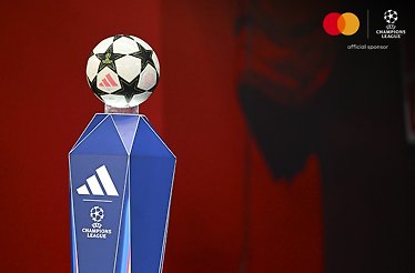 A football ball on a blue podium with the UEFA Champions League logo on it