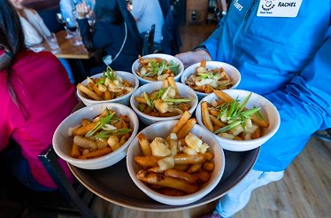 Vancouver's food served on four plates holded by four hands  