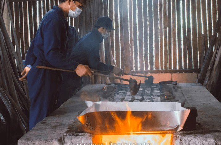 Saltmakers heating ingredients using traditional methods in a wood-fired workshop