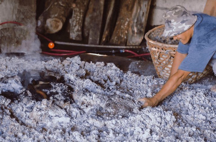 A saltmaker extracting and refining salt through meticulous hands-on techniques