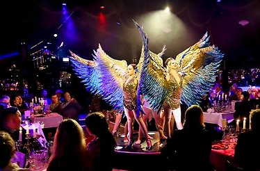 Artists in winged costumes performing at Teatro Munich.