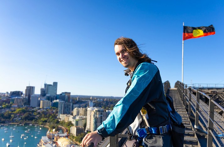 A man wearing BridgeClimb suits atop the Sydney Harbour Bridge.