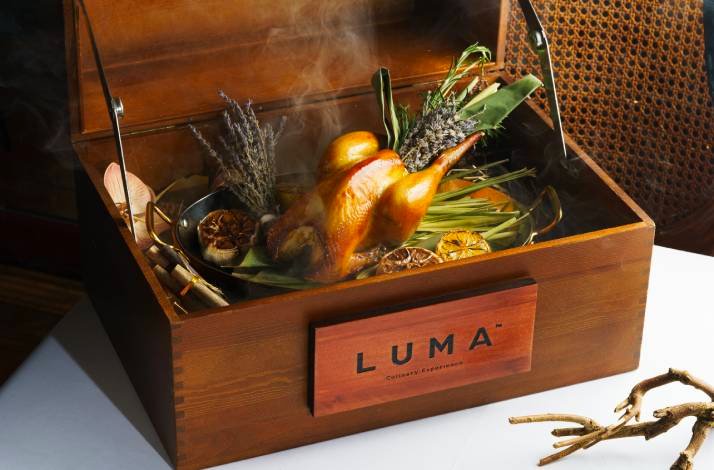 A signature Roasted Saam Wong Chicken served in a wooden presentation box at the LUMA restaurant in Hong Kong