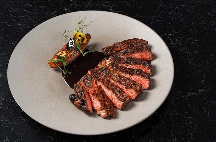 Flame-grilled steak dish served at VUE restaurant.