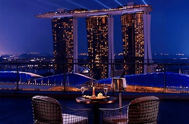 VUE rooftop dining with Marina Bay Sands view at night.